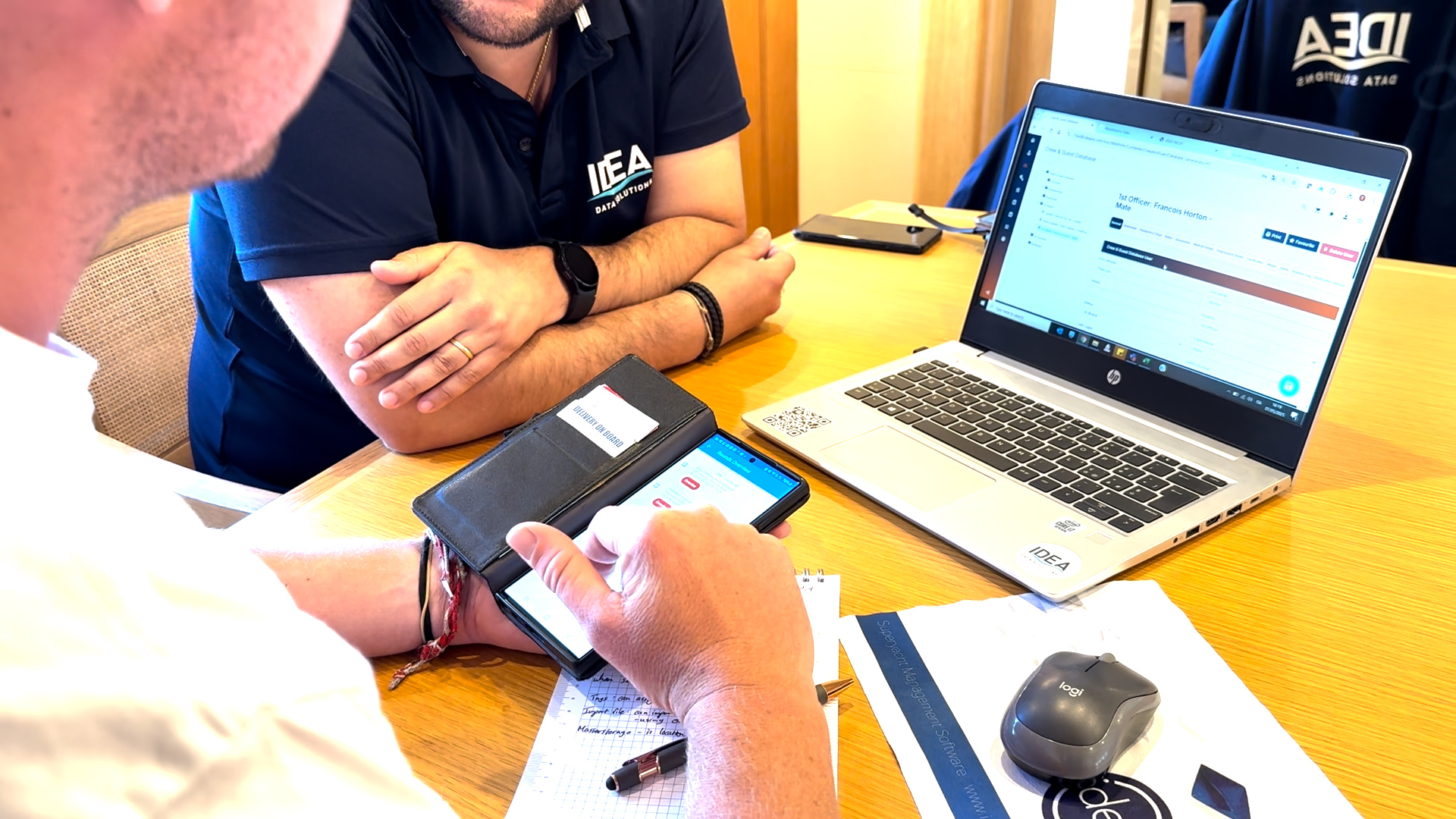 IDEA GT yacht management software on phone and laptop screen