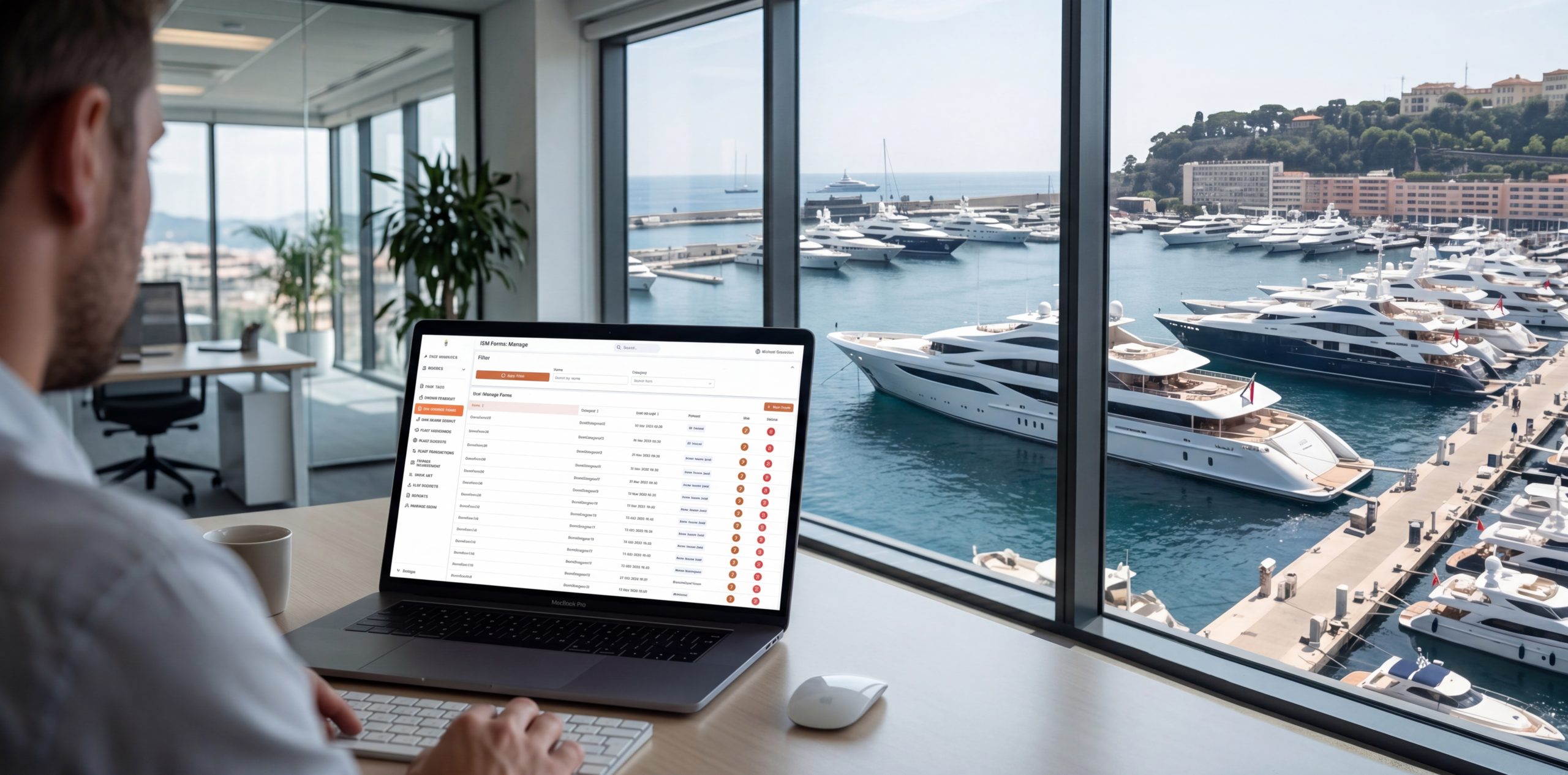 Manager at a laptop in an office overlooking a superyacht harbour